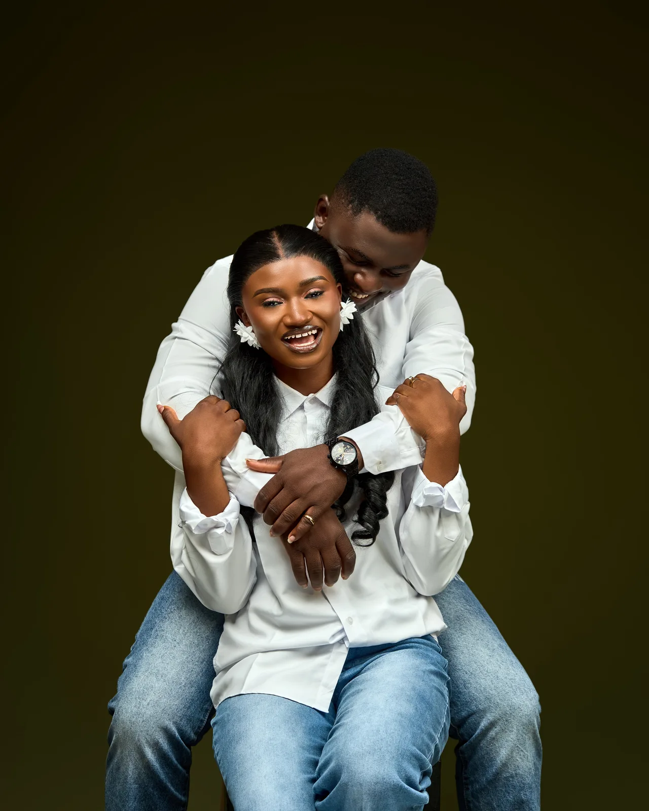 A playful embrace and laughter in matching white shirts