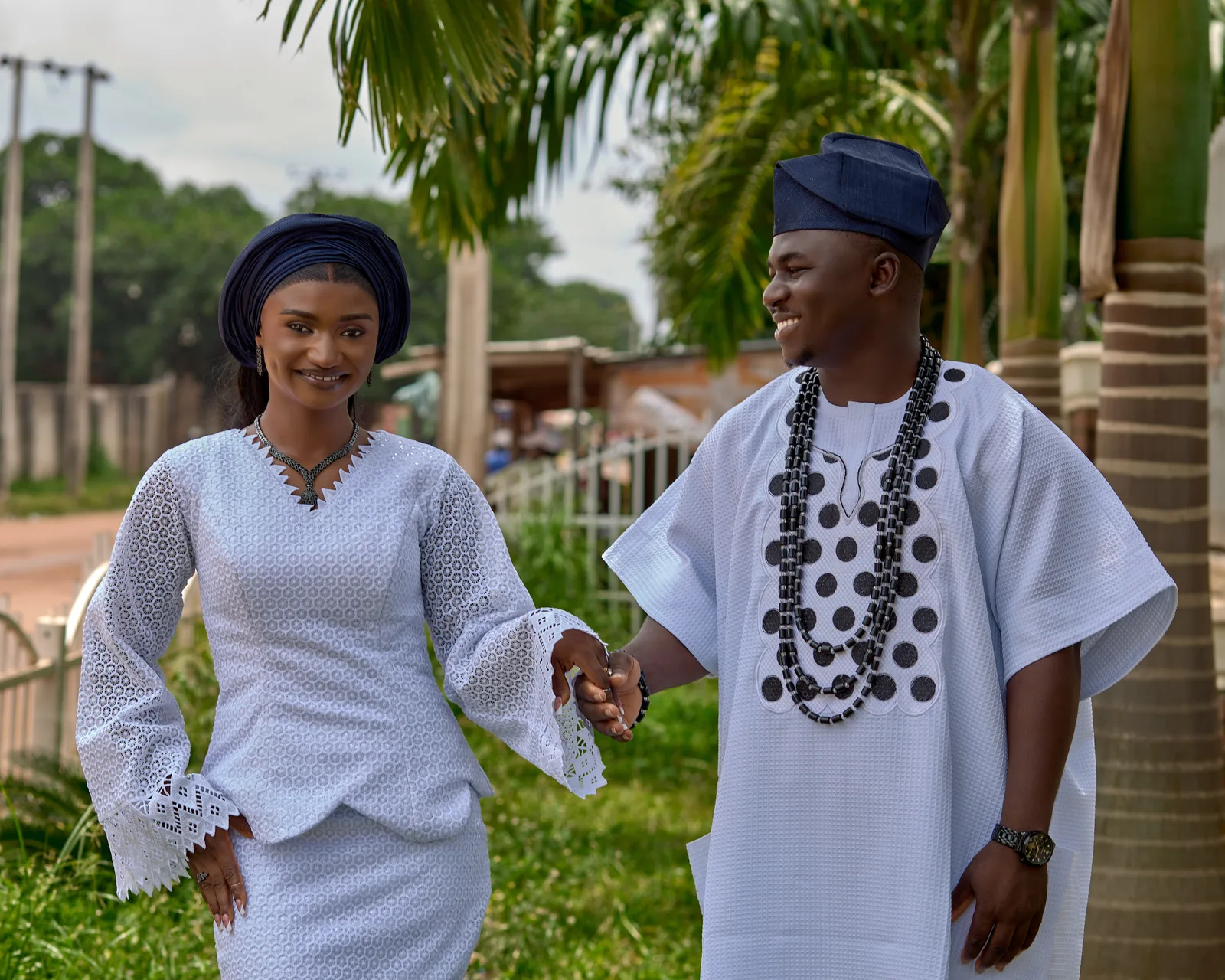 The couple holding hands in the garden